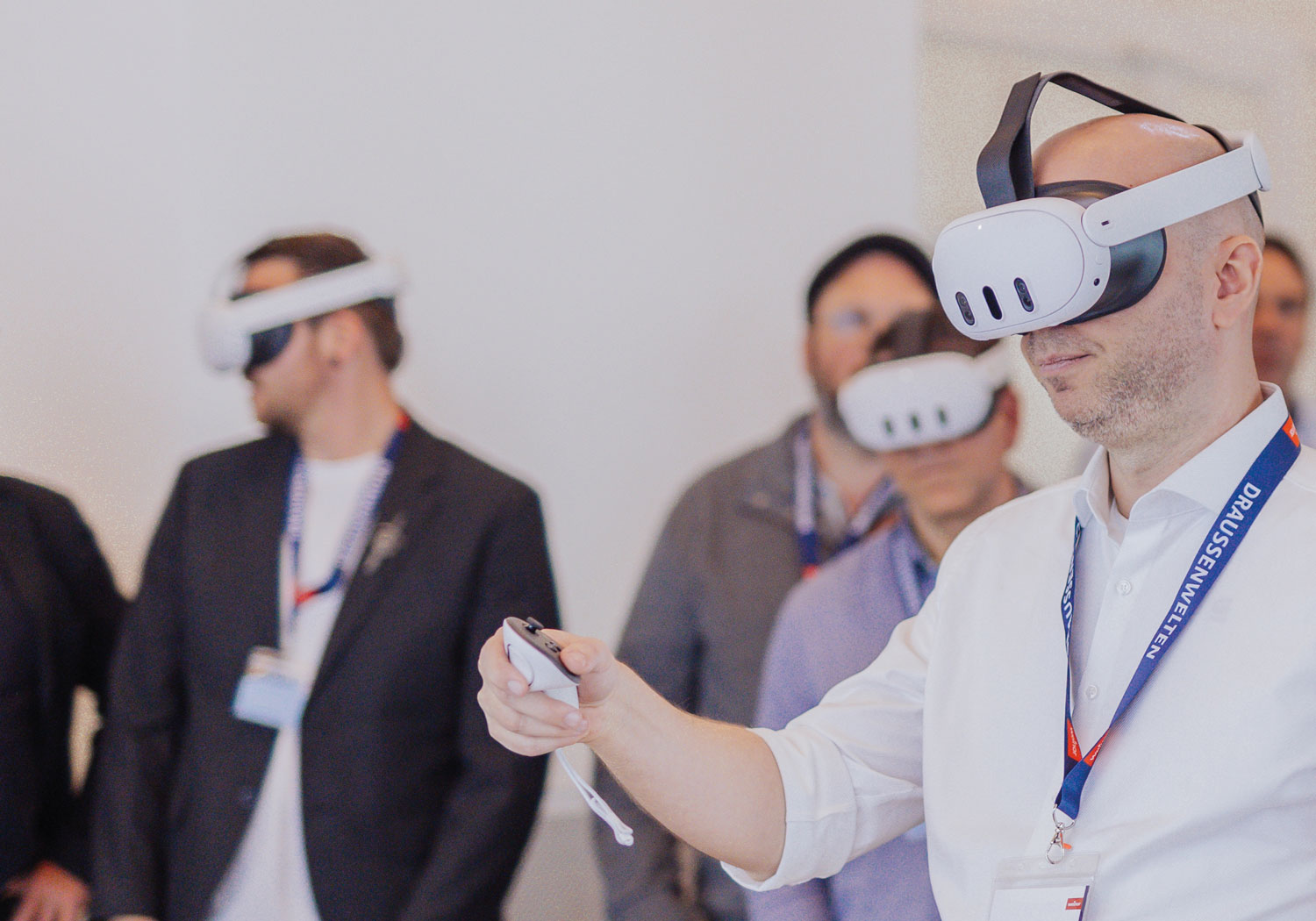 A group of people wearing virtual reality headsets in an indoor setting.