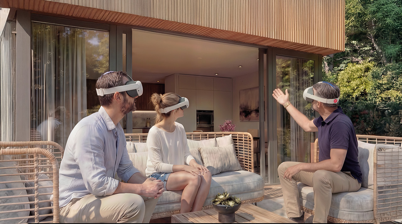 Three people wearing virtual reality headsets seated in a modern outdoor living space.