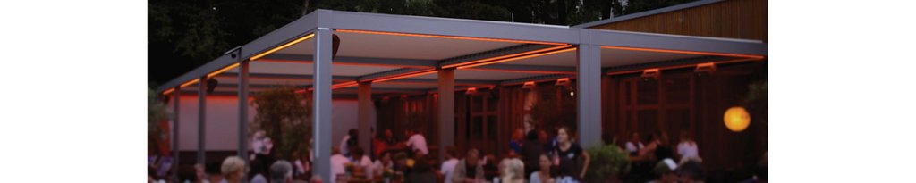Stylish outdoor seating area with a modern overhang and warm ambient lighting.