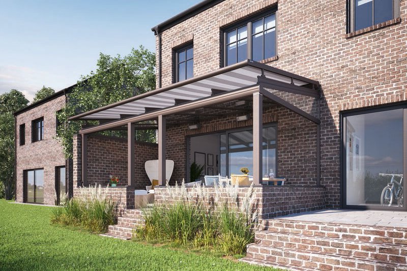A modern brick house with a terrace under an overhead structure, surrounded by grassy areas and trees. A modern brick house with a terrace under an overhead structure, surrounded by grassy areas and trees.