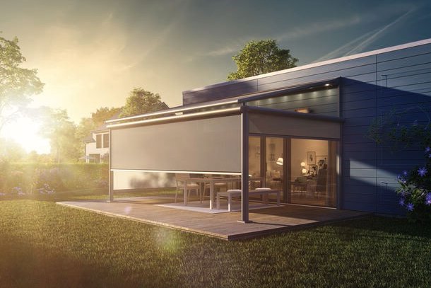 A modern home extension with a glass facade and an outdoor area, set against a sunset. A modern home extension with a glass facade and an outdoor area, set against a sunset.