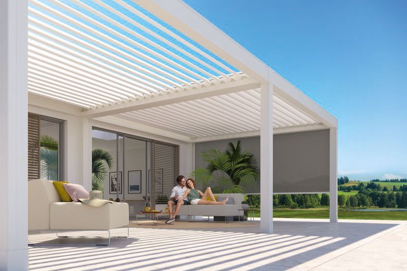 A modern outdoor space featuring a sleek structure with horizontal slats and a patio area. Bright sunlight and greenery. A modern outdoor space featuring a sleek structure with horizontal slats and a patio area. Bright sunlight and greenery.