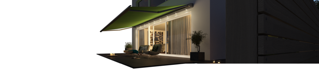 A green awning extending over a terrace with soft evening lighting and a modern house facade.