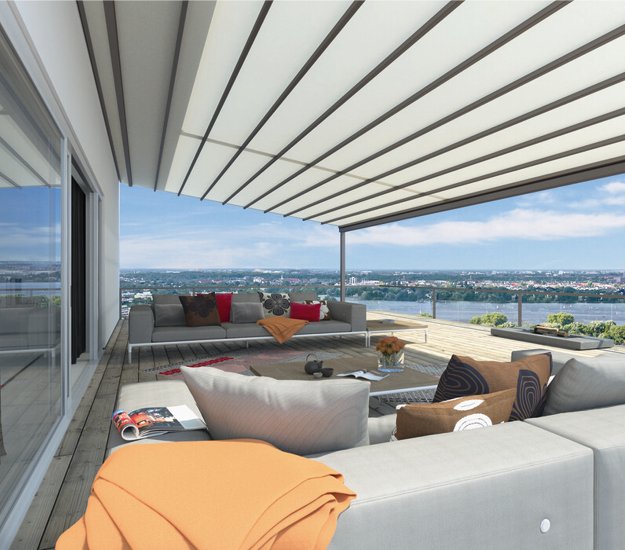 patio area with a large overhang, featuring various cushions and an inviting, spacious layout. 