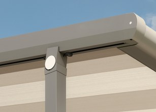 Detail view of a grey awning casing with a striped fabric. 