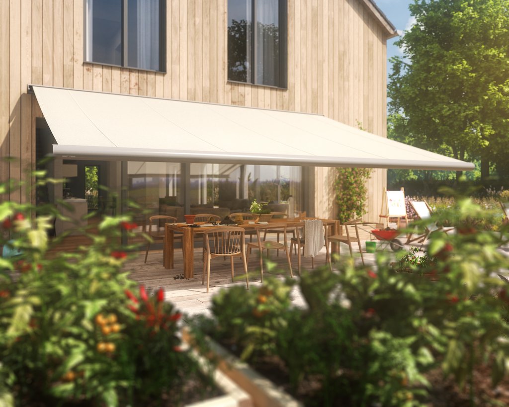 A white awning extends over a terrace situation with wooden furniture and greenery around.