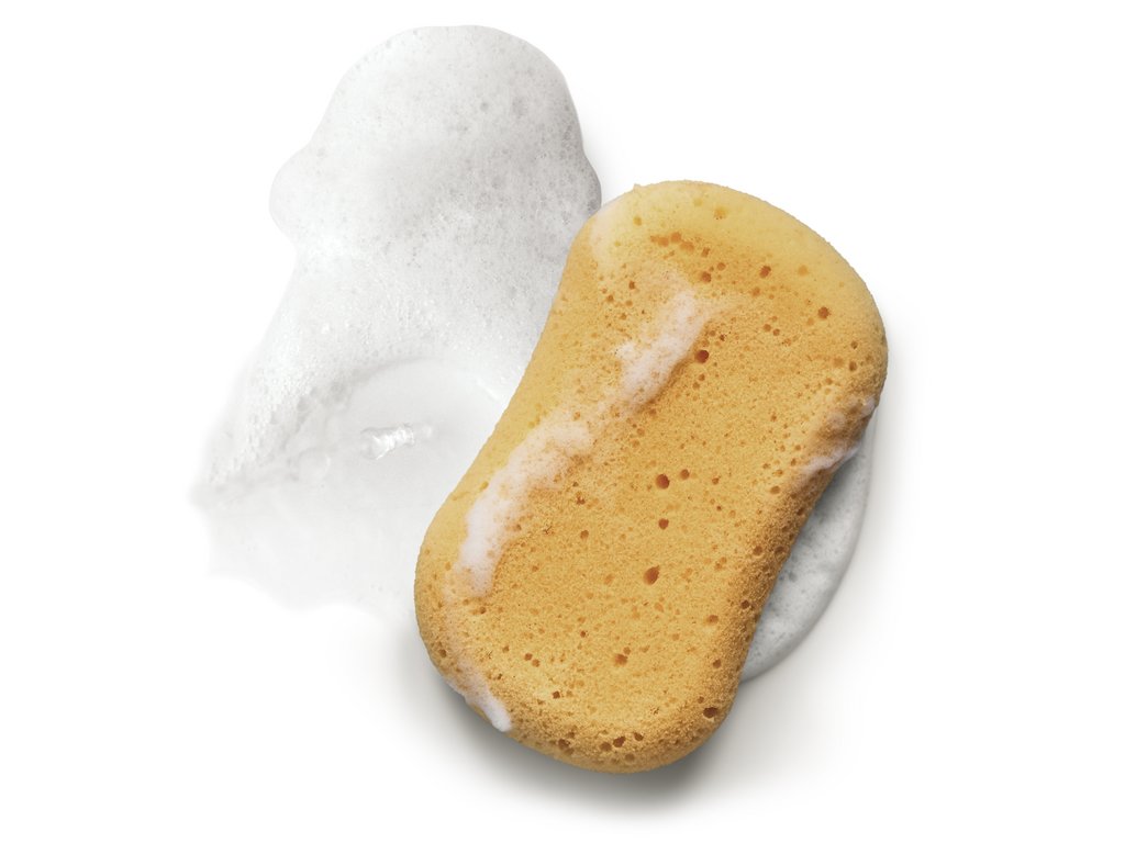 A sponge with bubbles, featuring an oval shape and a light yellow colour. A sponge with bubbles, featuring an oval shape and a light yellow colour.
