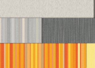 A collection of rolled fabrics in various colours and patterns, featuring stripes and blocks. 