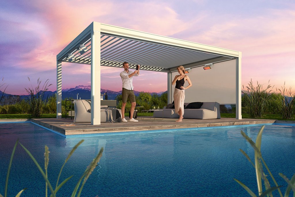 A modern open structure with a white overhead design near a pool, surrounded by greenery under a colourful sky.