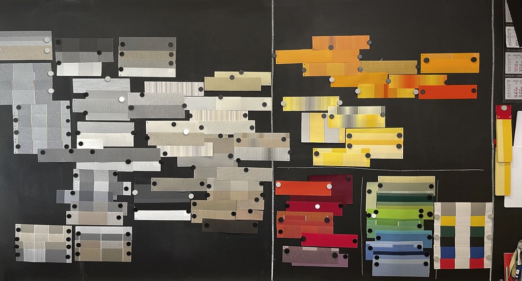 A collection of colour swatches in various shades on a black background, including yellows, reds, and metallics.