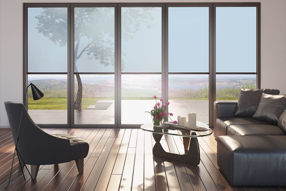 Modern interior with large glass panels, wooden floor, a comfortable sofa, and a stylish chair. Modern interior with large glass panels, wooden floor, a comfortable sofa, and a stylish chair.