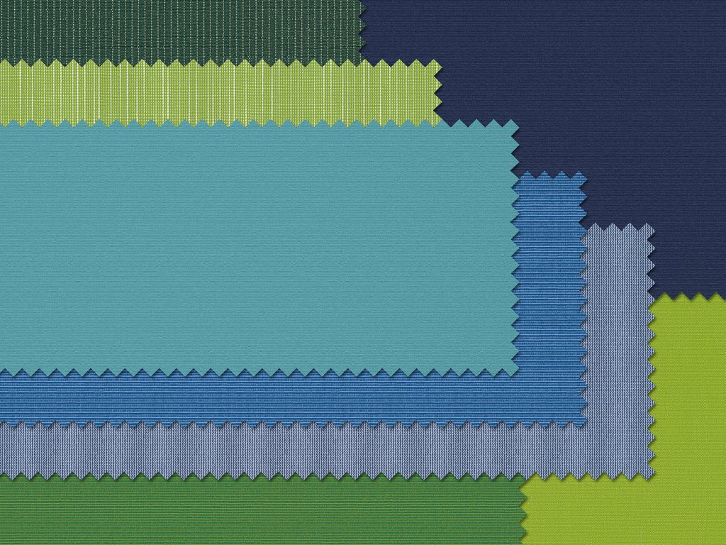 A collection of fabric swatches in varying shades of blue, green, and a hint of yellow, with zigzag edges.
