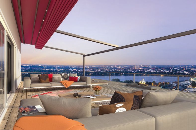 A modern outdoor space featuring a red awning, with seating and a panoramic view at dusk. A modern outdoor space featuring a red awning, with seating and a panoramic view at dusk.