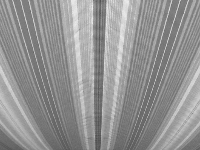 Striped pattern in shades of grey, creating a sense of depth and texture.