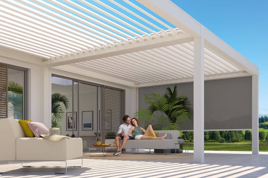 A modern outdoor space featuring a white overhanging structure with striped shading and seating area.