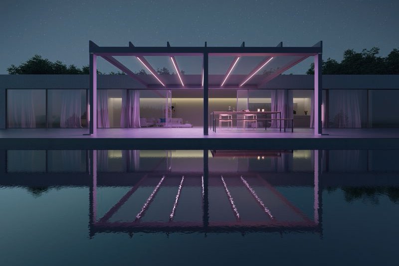 Modern structure with a canopy reflecting in the water, illuminated in soft purple light against a night sky. Modern structure with a canopy reflecting in the water, illuminated in soft purple light against a night sky.
