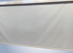 A grey surface with a smooth texture, featuring a light border at the top. 