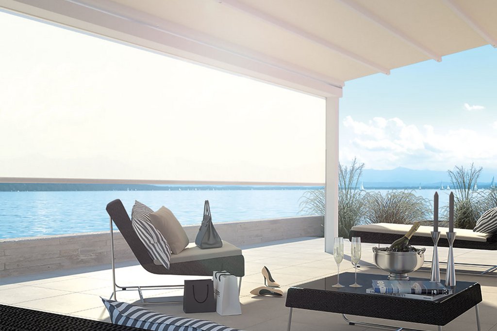 A modern outdoor terrace with a light-coloured overhead cover and stylish seating, overlooking a serene water view. A modern outdoor terrace with a light-coloured overhead cover and stylish seating, overlooking a serene water view.