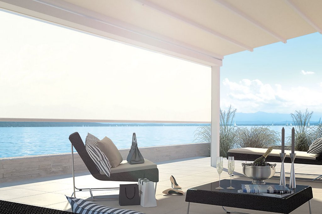 A modern outdoor terrace with a light-coloured overhead cover and stylish seating, overlooking a serene water view. A modern outdoor terrace with a light-coloured overhead cover and stylish seating, overlooking a serene water view.