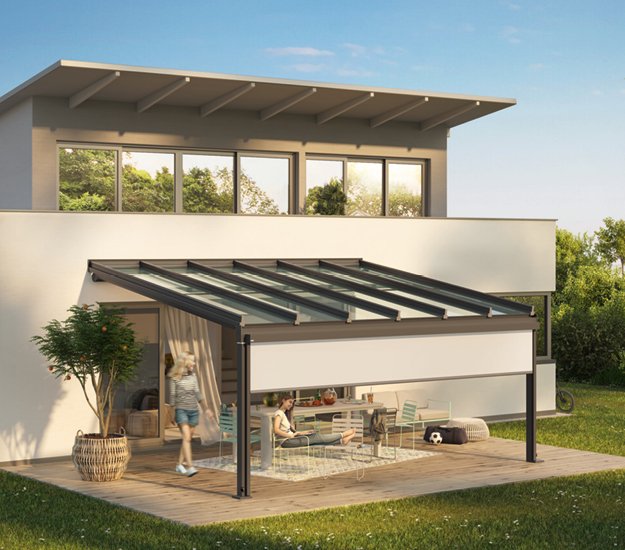 A modern terrace with a glass roof overhang, featuring a family enjoying the outdoor space. 
