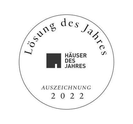 Circular logo featuring text and a logo design, predominantly in black and white.