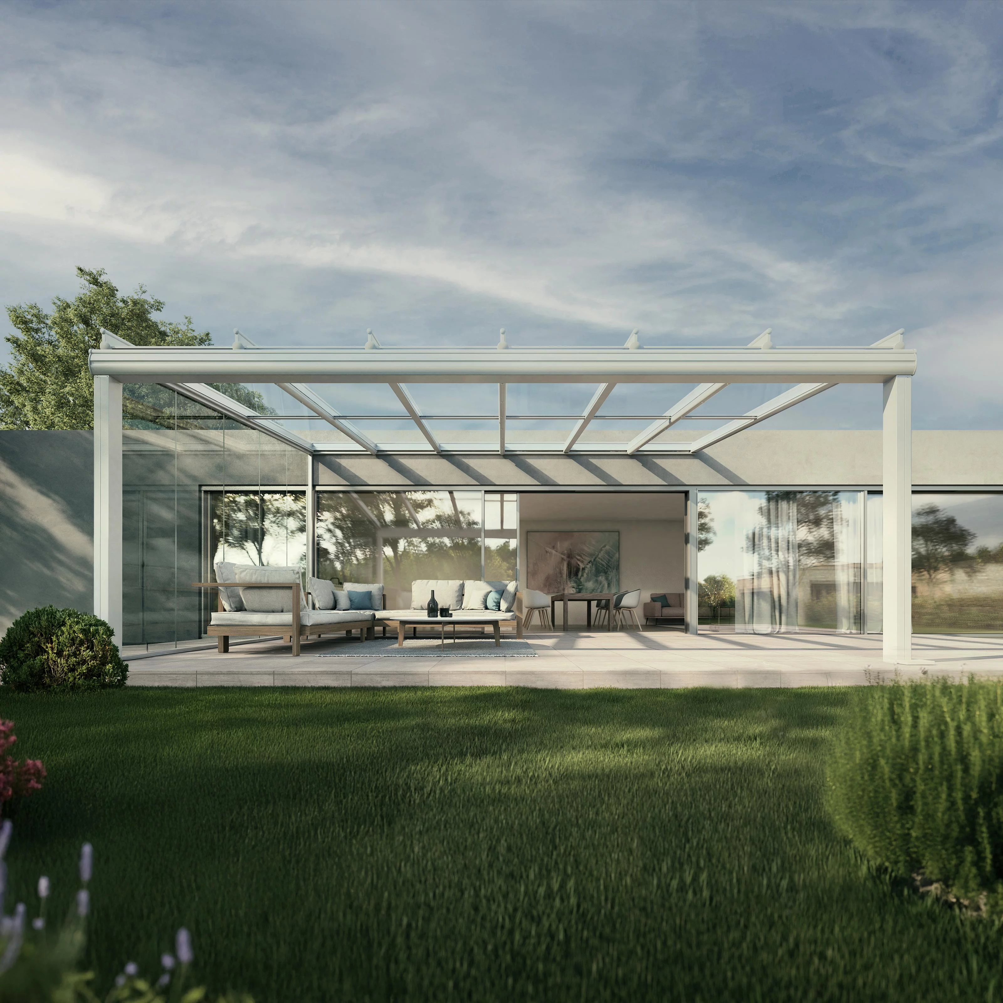 A modern terrace with a glass-roofed structure, surrounded by greenery and clear skies.