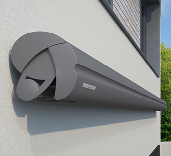 A grey, elongated awning box on a wall with a rounded design.