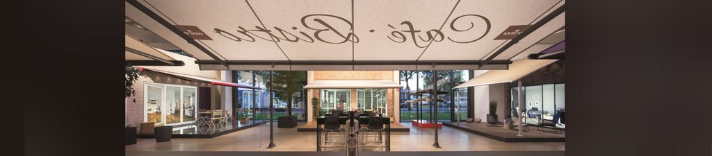 A stylish café entrance featuring a large awning, glass walls, and a modern interior design.