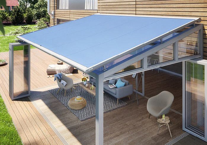 A terrace situation with a blue awning, glass walls, and seating area on wooden flooring.