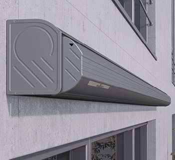 Grey elongated box with a rounded design, mounted on a building wall.