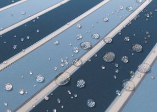 Water droplets on striped fabric in shades of blue. 