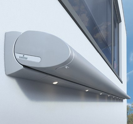 A sleek grey awning box mounted on a building wall with integrated LED spots.